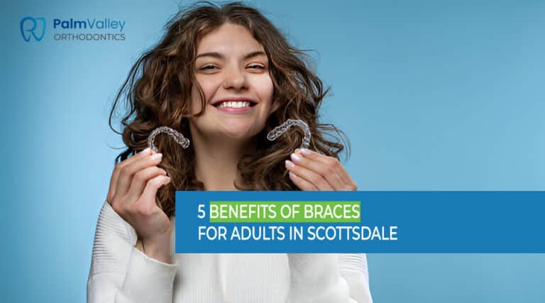 Adult woman holding invisible aligners for dental correction in Scottsdale